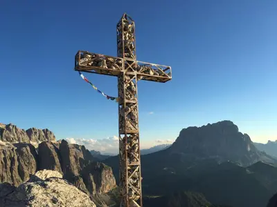 a wooden cross on the top of a mountain at Residence La Planta in Ortisei