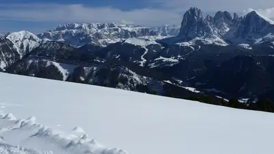 a snow covered mountain range with mountains in the background at Residence La Planta in Ortisei