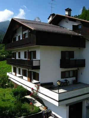 a large white building with balconies on the side of it at Appartamenti Dolomiti in Colcerver