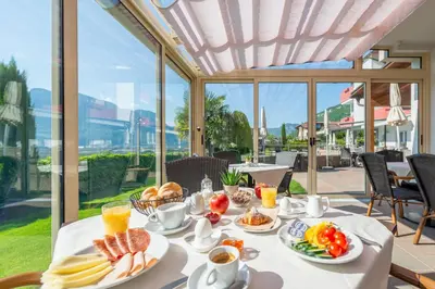 a breakfast table with breakfast foods and drinks on it at B&B Garni Erika in Termeno