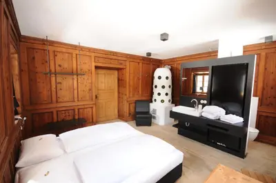 a bedroom with a white bed and a sink at Steinwandterhof in Braies