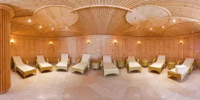 a room with chairs and tables in a building at Frida am Wald in Rasùn di Sotto