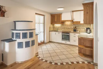 a kitchen with a stove in the middle of it at App. Désirée in San Vigilio Di Marebbe