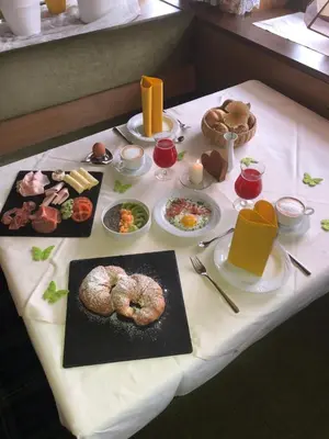 a table with food on top of a table at Pension Grafenau in Schenna