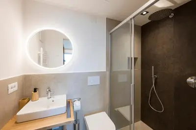 a bathroom with a sink and a shower at Pension Grafenau in Schenna