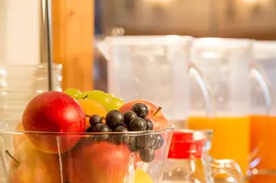 a bowl of fruit sitting on top of a table at Hotel Garni la Stua in Selva di Cadore