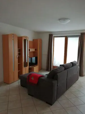 a living room with a couch and a television at Villetta Muncion in Pozza di Fassa
