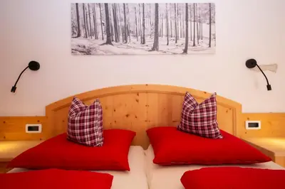 a bedroom with two red pillows on a bed at Editlodge 