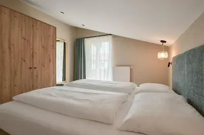 a large white bed in a room with a window at Art Residence Josefshof in Lagundo