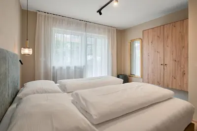 three beds in a room with a window at Art Residence Josefshof in Lagundo