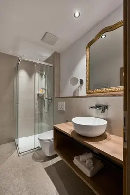 a bathroom with a sink and a glass shower at Art Residence Josefshof in Lagundo
