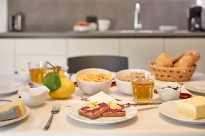 a table topped with plates of food and bread at Residence Settsass in Colfosco