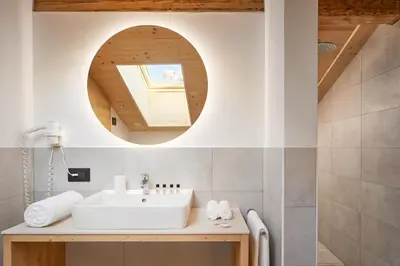 a bathroom with a sink and a mirror at Residence Settsass in Colfosco