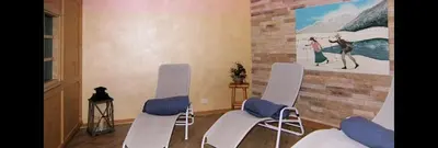a room with three chairs and a painting on the wall at DOLOMITI appart&rooms in Varena