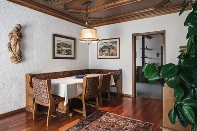 a dining room with a table and chairs at Kronplatz Lodge Dolomites in San Vigilio Di Marebbe