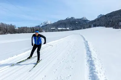 a man is cross country skiing in the snow at Hotel Dolomiten in Monguelfo