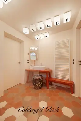 a bathroom with a sink and a mirror at Goldengel Design - Suiten im historischen Ortskern von Kaltern in Caldaro