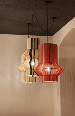 two chandeliers hanging from the ceiling in a room at Goldengel Design - Suiten im historischen Ortskern von Kaltern in Caldaro