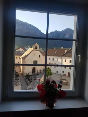 a window with a vase of flowers in a window sill at Dolomitica, nuovo, fino a 6 Persone in Vols am Schlern