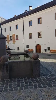 a building with a fountain in front of a building at Dolomitica, nuovo, fino a 6 Persone in Vols am Schlern
