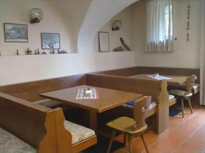 a dining room with a table and a table and chairs at Casa Montana S. Maddalena in San Vito di Cadore