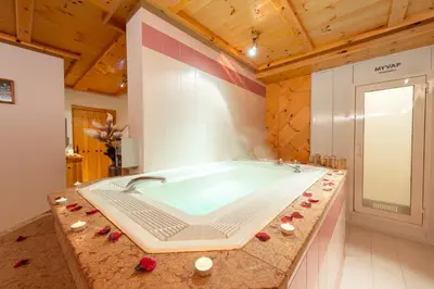 a large bath tub in a room at Spires Hotel in Canazei