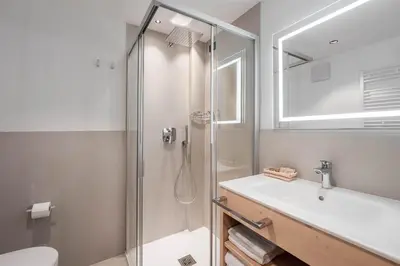 a bathroom with a shower and a sink at Spires Hotel in Canazei