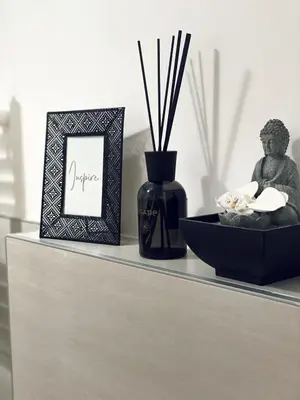 a shelf with a statue and a picture and a vase at Chic In The City in Bolzano