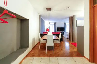 a dining room with a table and chairs at Laubenapartment in Merano