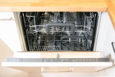 an open dishwasher with dishes inside of it at Laubenapartment in Merano