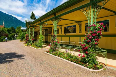 a yellow building with flowers in front of it at Laubenapartment in Merano