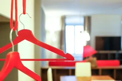 two red hangers are hanging in a room at Laubenapartment in Merano