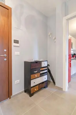 a room with a dresser in a room with a door at Penthouse Jolanda Meran-o in Merano