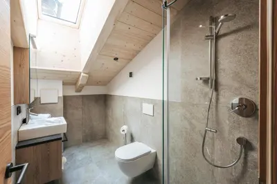 a bathroom with a shower and a toilet and a sink at Lochbauer in Meltina