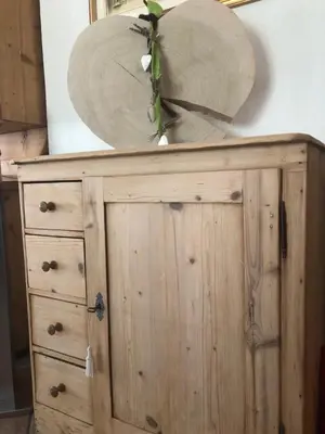 a wooden dresser with a surfboard on top of it at Albergo Bernard in Canazei