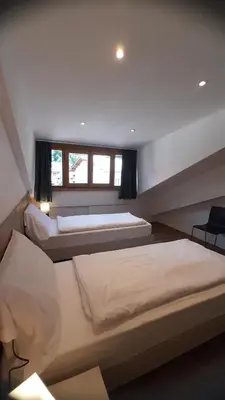 a bedroom with two beds and a window at Vacanze Arcobaleno in Predazzo