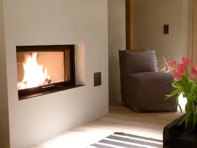 a living room with a fireplace and a couch at Pension Hauenstein in Lagundo