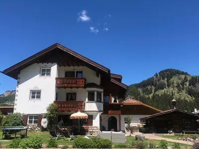 a toy room with a bunk bed and a table at Appartamenti Hacoli in Selva di Val Gardena