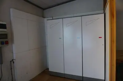 a closet with white cabinets in a room at Casa Dorich in Pozza di Fassa