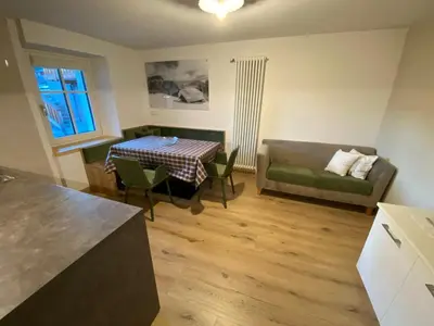 a living room with a table and a couch at Casa Dorich in Pozza di Fassa
