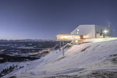 a building on top of a snow covered mountain at Ariala Apartments in Falzes