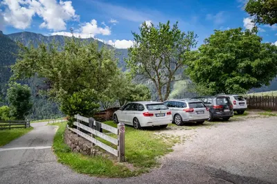 a group of cars parked in a parking lot at Oberpiskoihof in Funes
