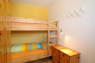 a bedroom with two bunk beds and a desk at Oberpiskoihof in Funes