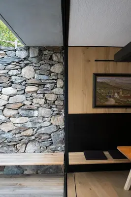 a room with a stone wall and a bench at Hotel Pacherhof in Bressanone