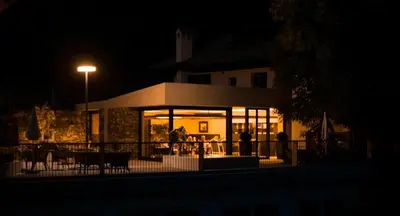 a building lit up at night with a street light at Hotel Pacherhof in Bressanone