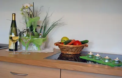 a counter with a basket of fruit and a bottle of wine at Gasthof Weidmannshof in Bressanone