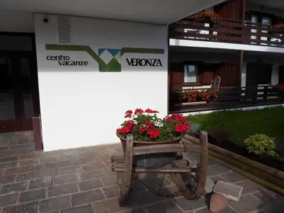 a living room with a couch and a table at Appartamenti Dolomiti con piscina e sauna in Cavalese