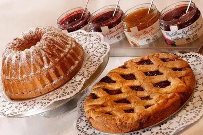 a table with two cakes and a pie on plates at Hotel Hubertusstube in Laion