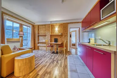 a kitchen and living room with a couch and a table at Appartements Riegelehof in Laion