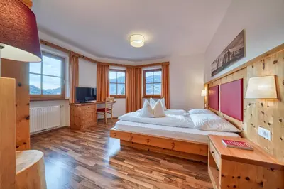 a bedroom with a large bed and a desk at Appartements Riegelehof in Laion